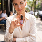 Woman wearing Arouse-Rx pheromone perfume for women, vanilla and white florals at a cafe while a man looks over