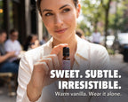 Woman holding a bottle of Arouse-Rx pheromone perfume for women, vanilla and white florals